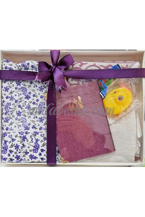 Box containing kids praying clothes Holy Quraan Rosary and a toy