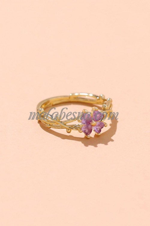 Golden ring with purple flower