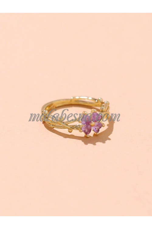 Golden ring with purple flower