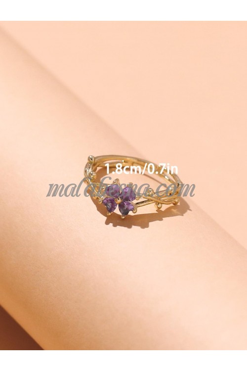 Golden ring with purple flower