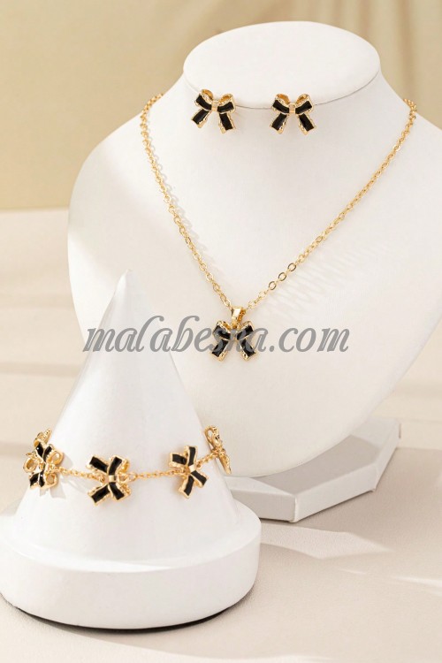 Golden set of earrings necklace and bracelet with black bow tie