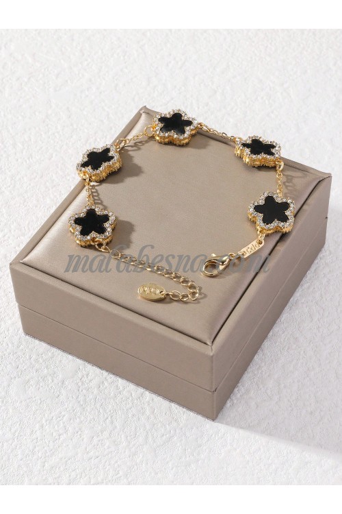 Golden bracelet with black flower and diamonds