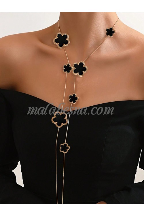 Long golden necklace with black flower shape