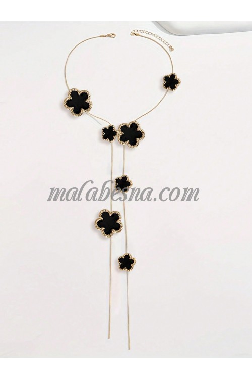 Long golden necklace with black flower shape